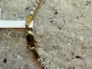 Guld tennisarmbånd i 14 kt. med zirkoner 