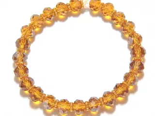 Armbånd, krystal, topas. gyldent, elastik