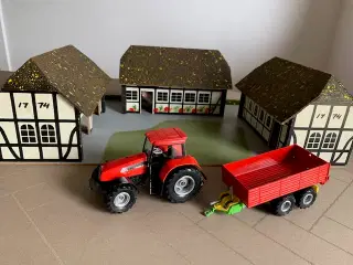 Bondegård med traktor og dyr