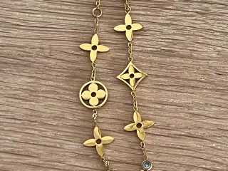 Flot armbånd i guldfarve. 