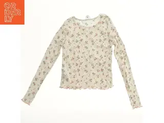 Bluse med blomsterprint fra H&M (str. 152)