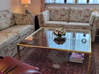 Sofabord med glasplade og guldbelagt stel.