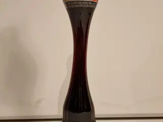 Coca Cola kurvet flaske, der indeholder den velken