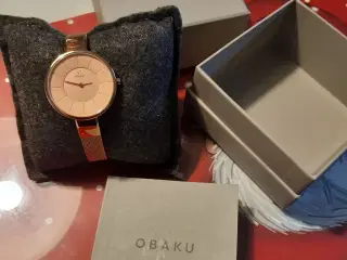Obaku sol i rosegold med mesh lænke.