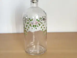 Klukflaske, klart glas med blomsterdekoration